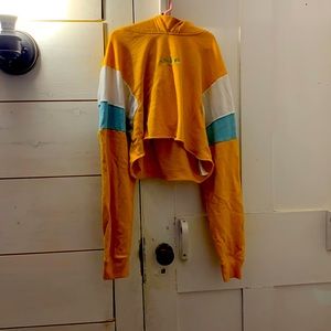 Mainly yellow cropped sweatshirt with blue and white on the sleeves